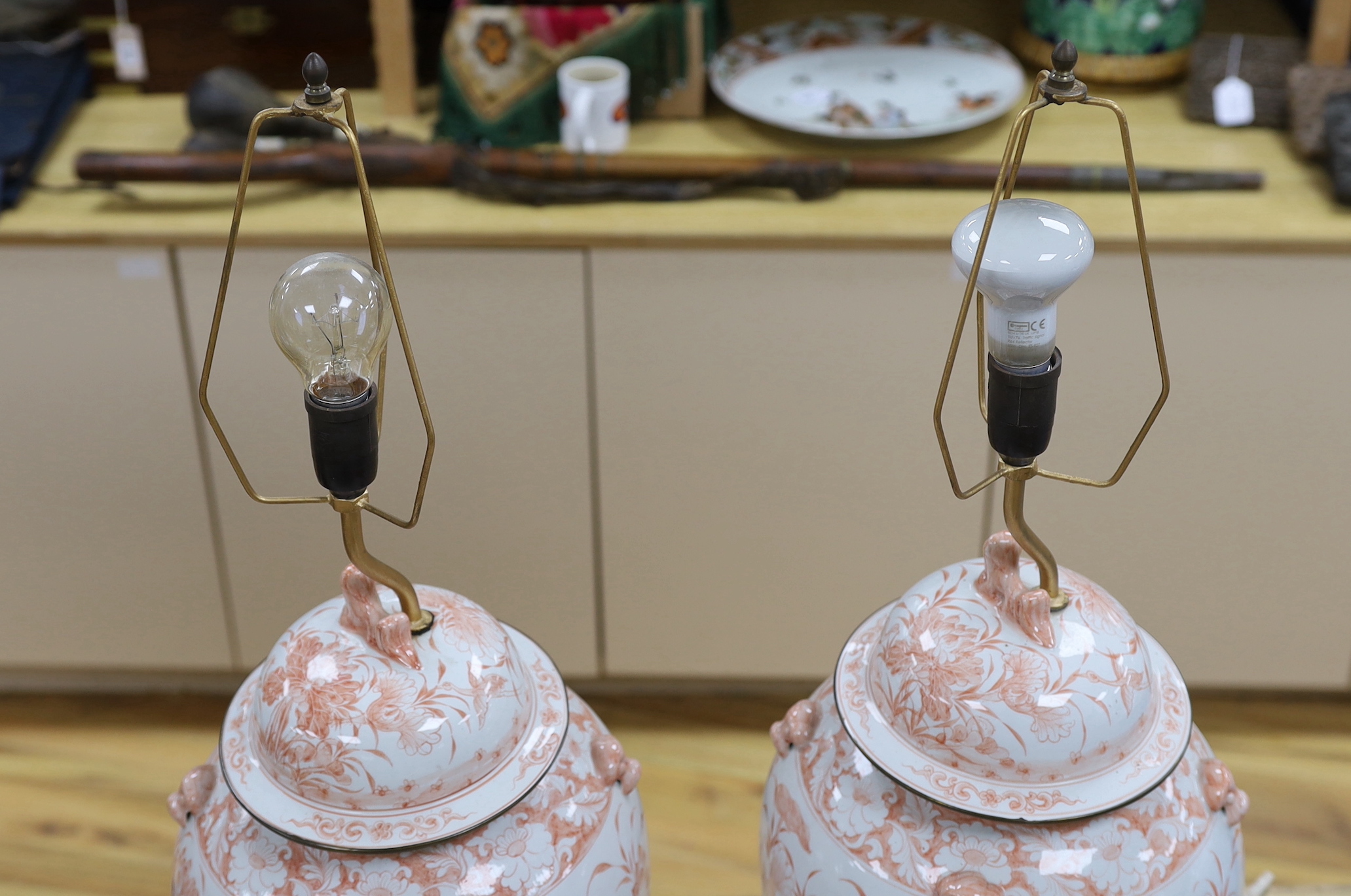 A pair of Chinese style iron red porcelain table lamps